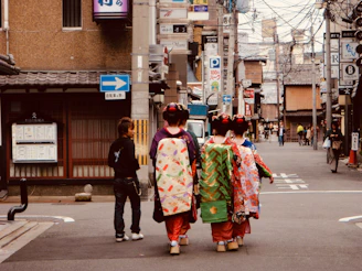 a group of people in traditional dress walking down a street