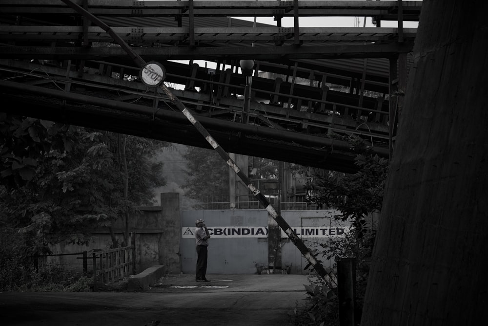 a person standing under a bridge