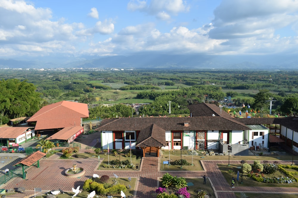 a large building with many windows and trees in the back