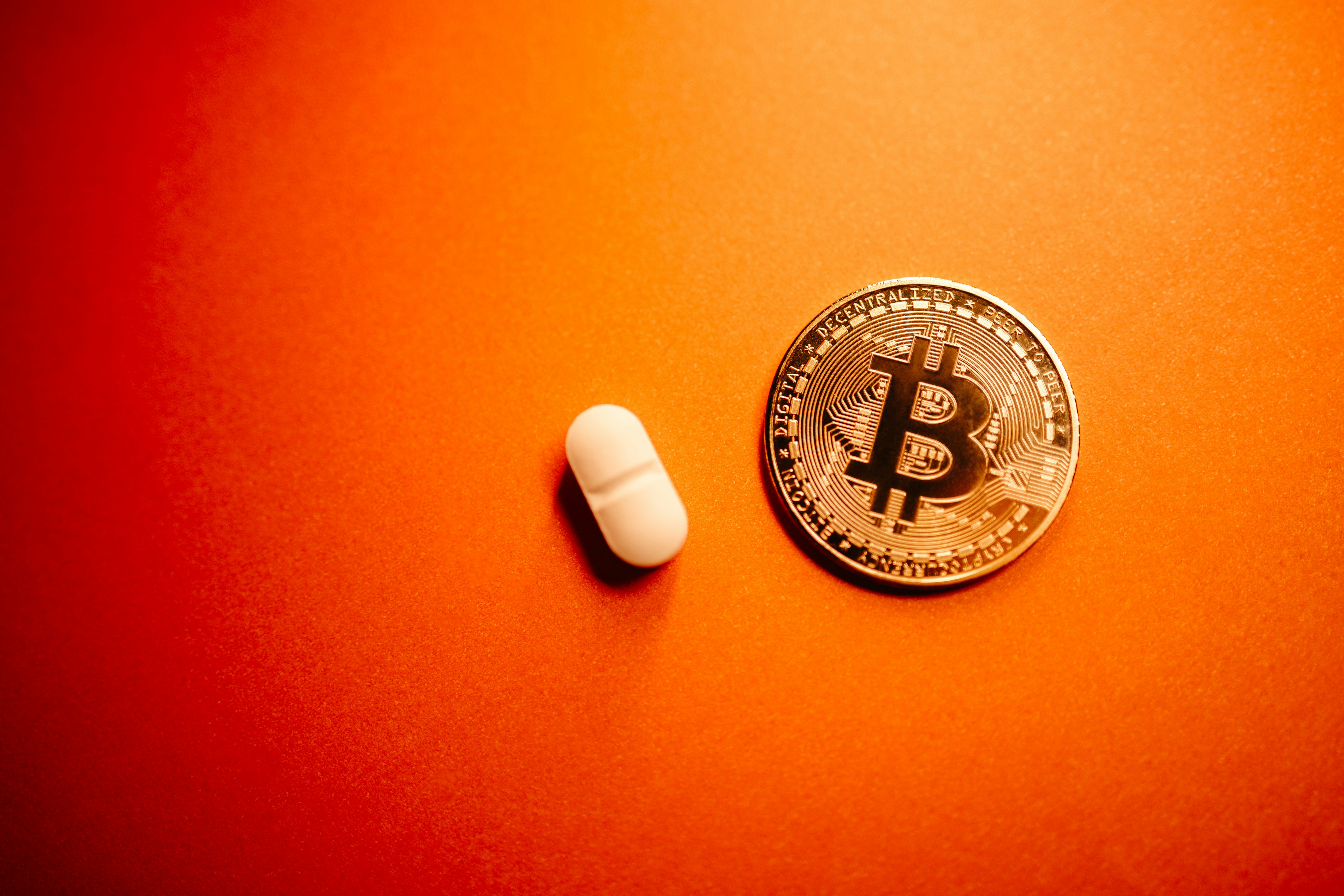 A bitcoin surrounded by pills in a bowl photo – Free Money Image on Unsplash