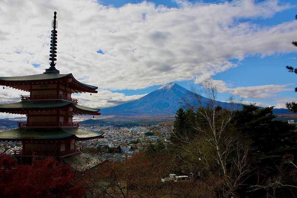 a tall tower with a mountain in the background