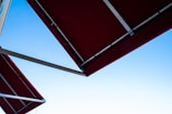 Fabricated stainless steel canopy structure installed outdoors under a clear sky.
