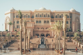 a large building with palm trees in front of it
