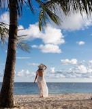 a person in a white dress on a beach