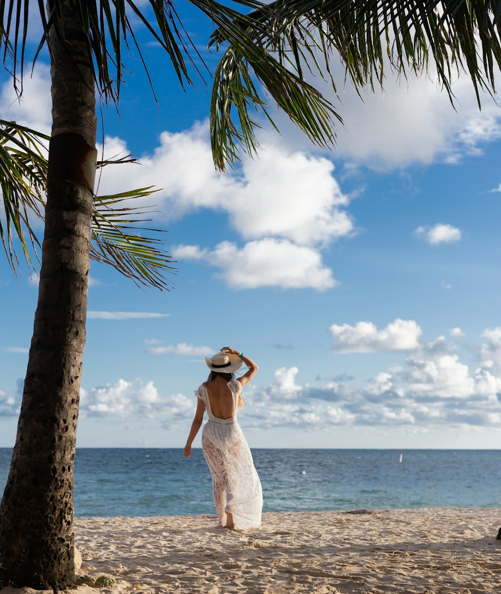 a person in a white dress on a beach