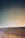 A serene desert landscape under a starry night sky with soft glowing mineral springs.