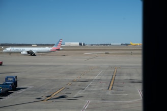 A sleek training aircraft taxiing on the runway under a clear blue sky at Skyspeedr Aviation.