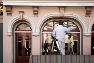 a man standing on a ladder