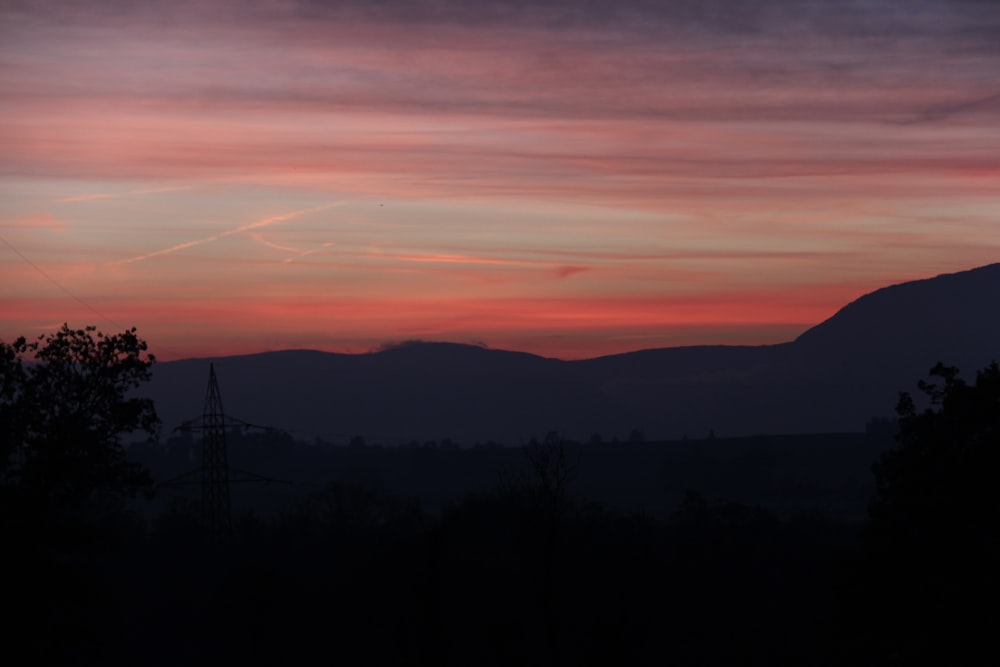 a sunset over a mountain range