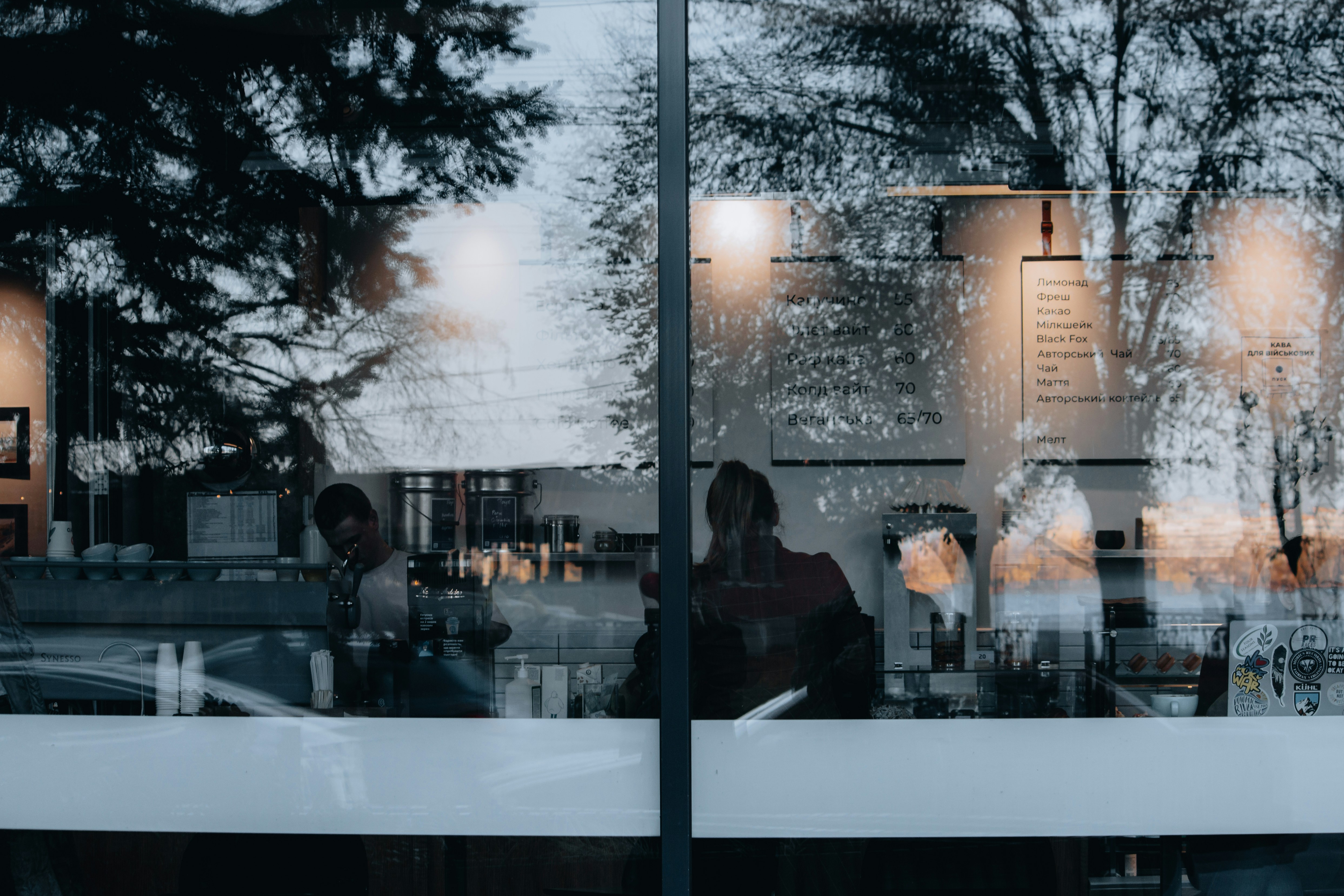 a couple of people sitting at a table in front of a window