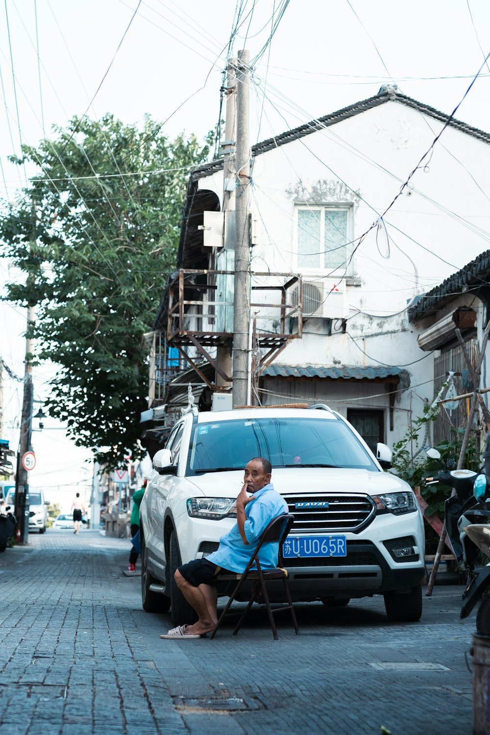 a person sitting in a chair outside a building