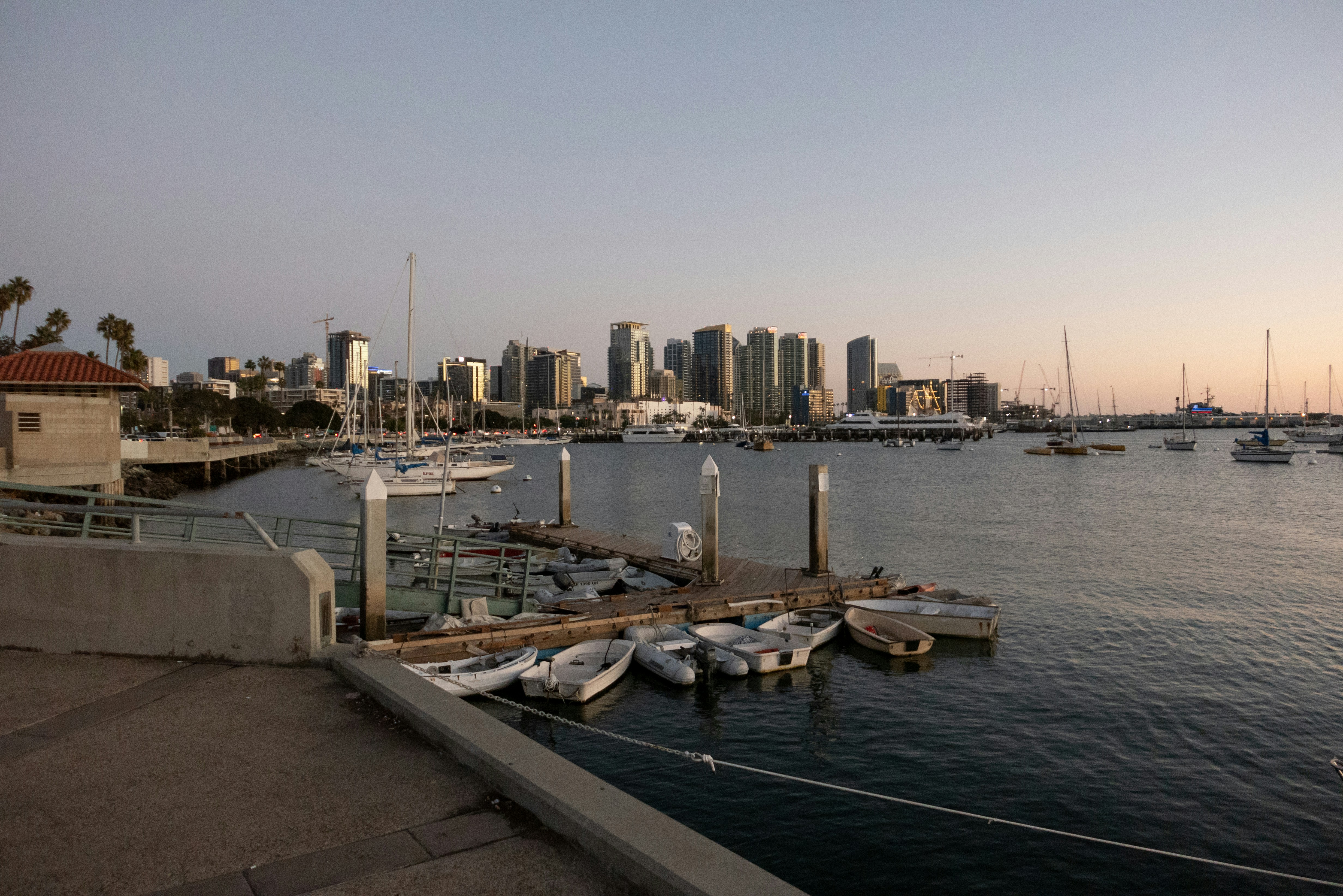 a body of water with boats in it and a city in the background