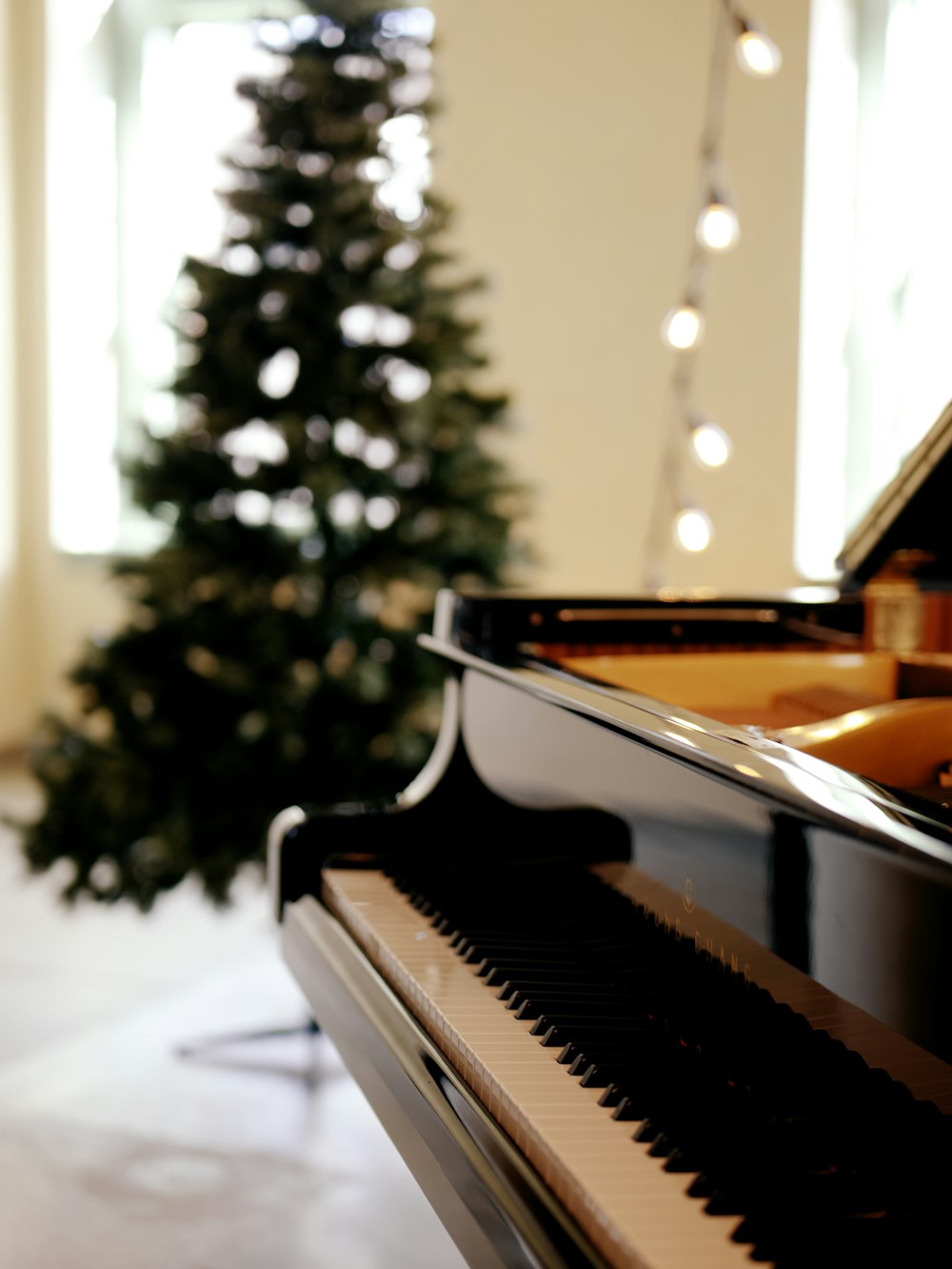 a piano in front of a christmas tree