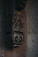 Intricate burnt wood art displayed on a wall, showcasing detailed patterns and craftsmanship.