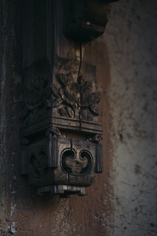 Hand-carved wooden wall hanging showcasing natural wood grain and artistic patterns