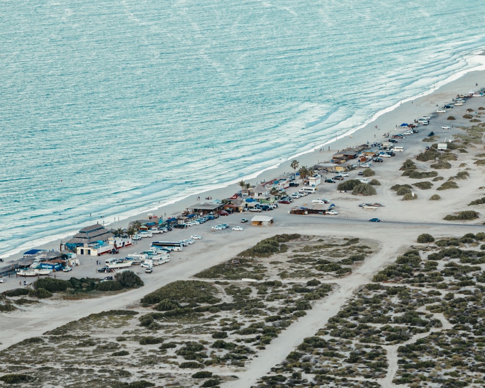 a beach with many people and buildings