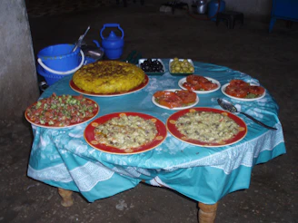 A rustic wooden table with traditional Mexican dishes served in colorful pottery.