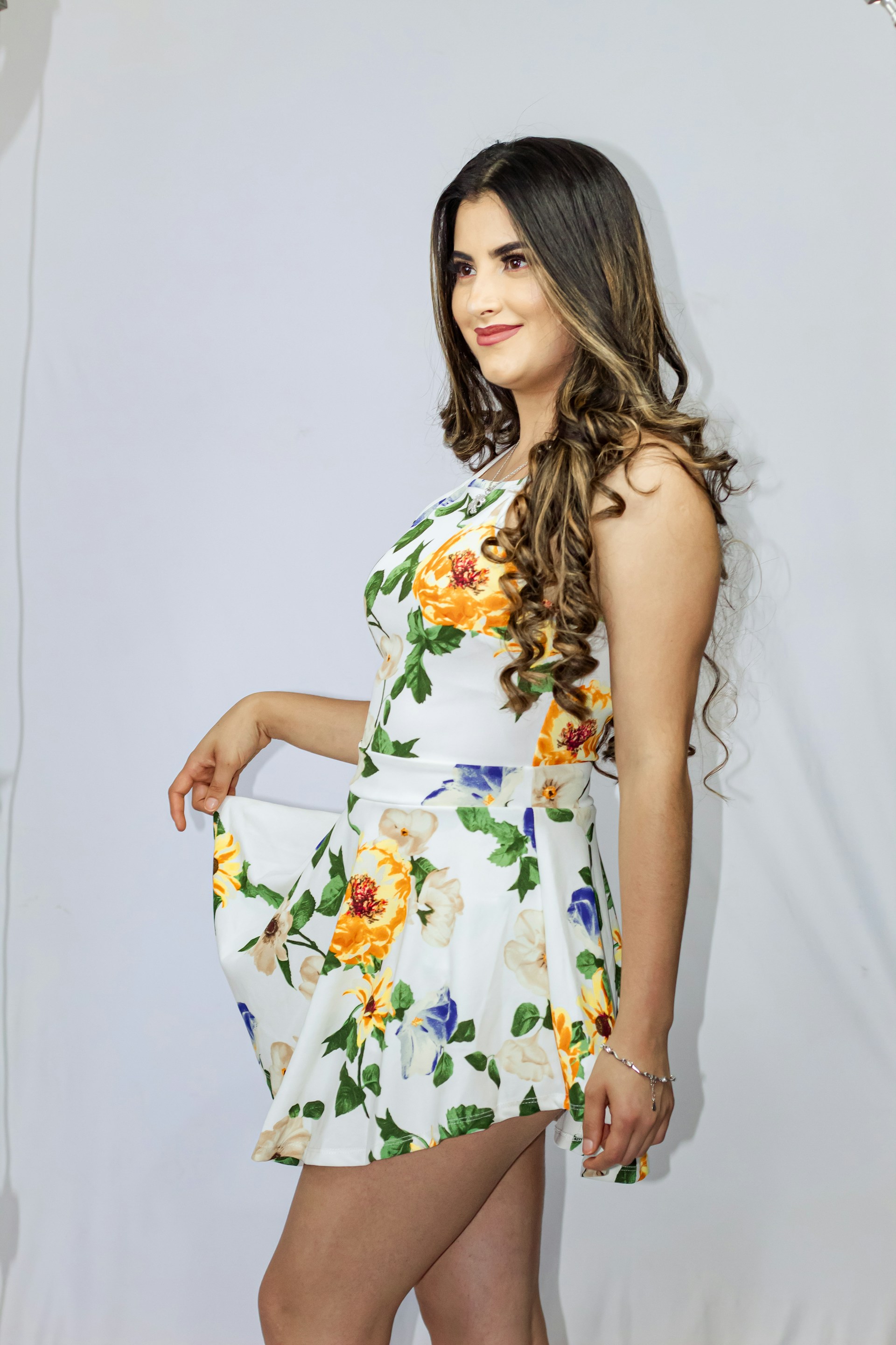 woman wearing yellow long-sleeved dress under white clouds and blue sky during daytime
