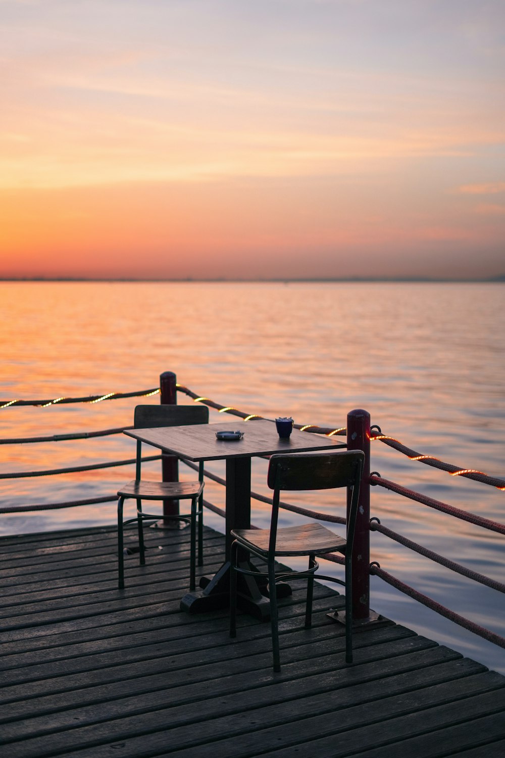 a table and chairs on a dock