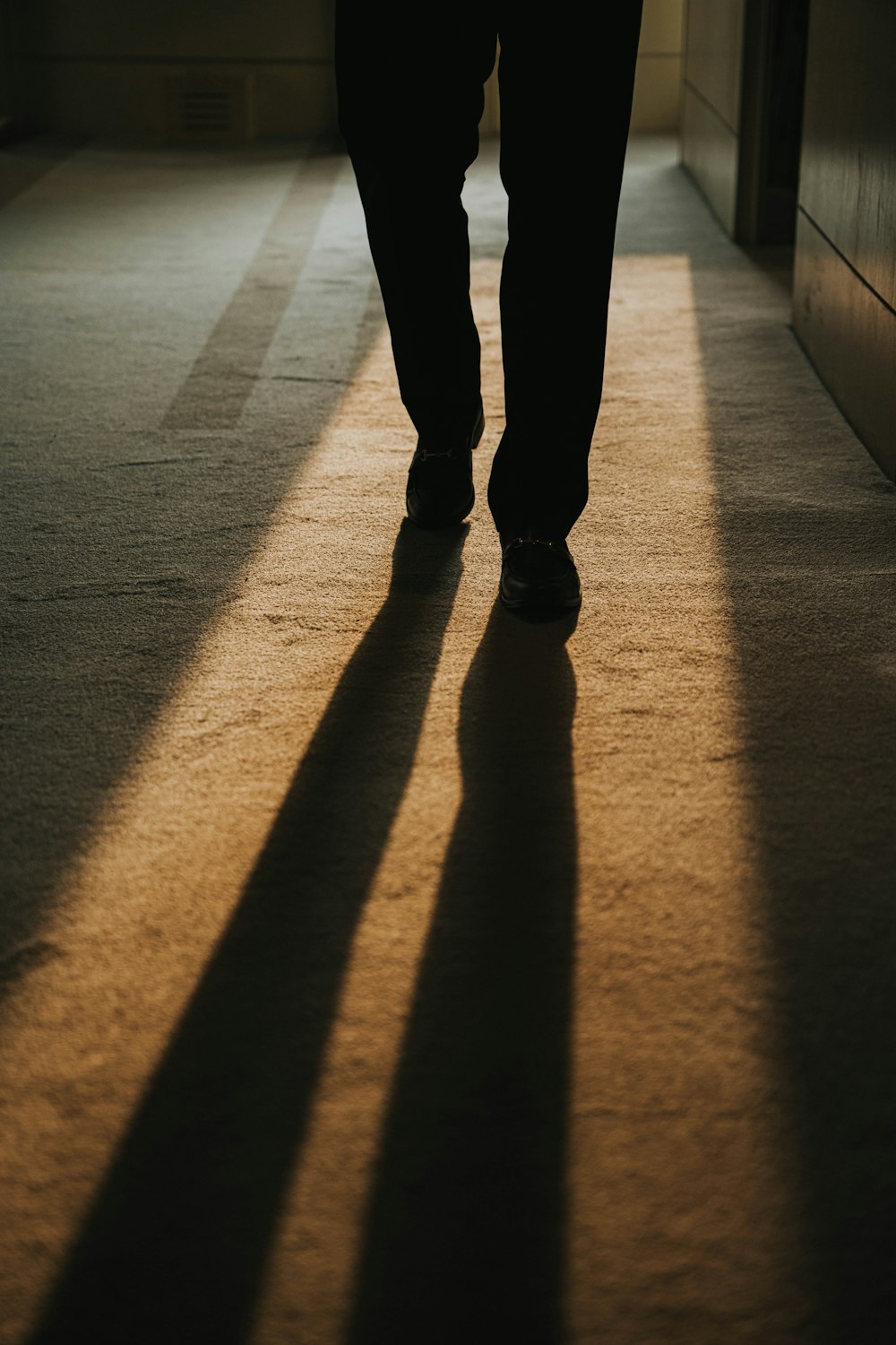 a person's shadow on a tile floor