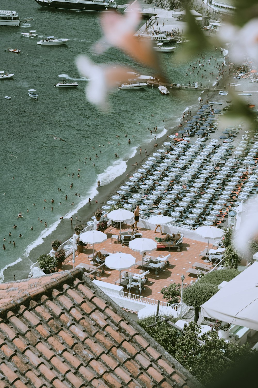 a beach with umbrellas and boats