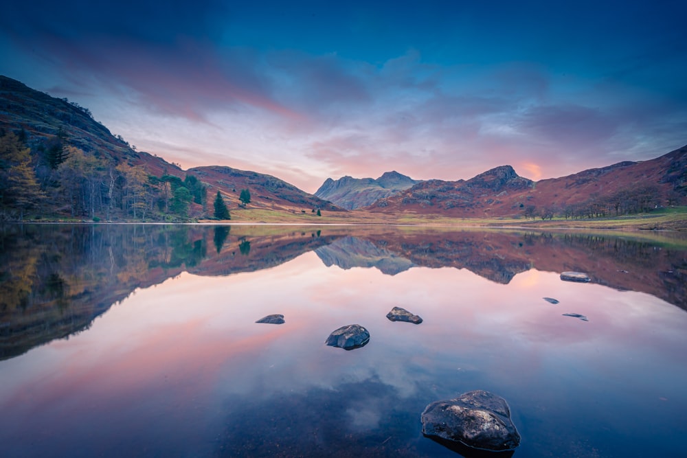 a lake with mountains in the background