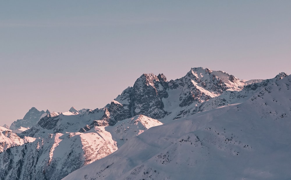 a snowy mountain with a cloudy sky