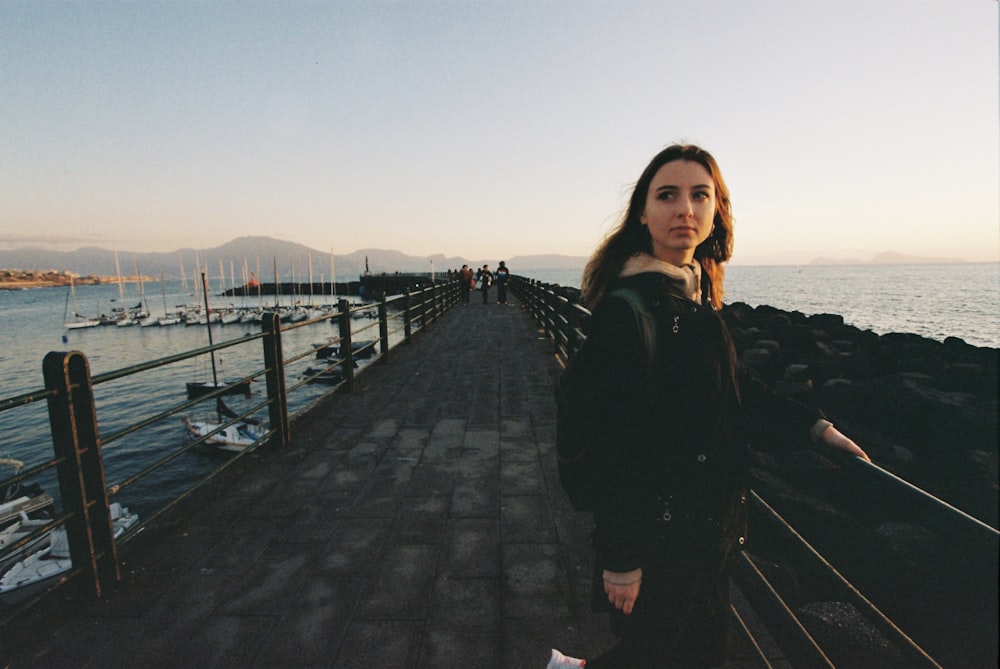 a woman standing on a dock