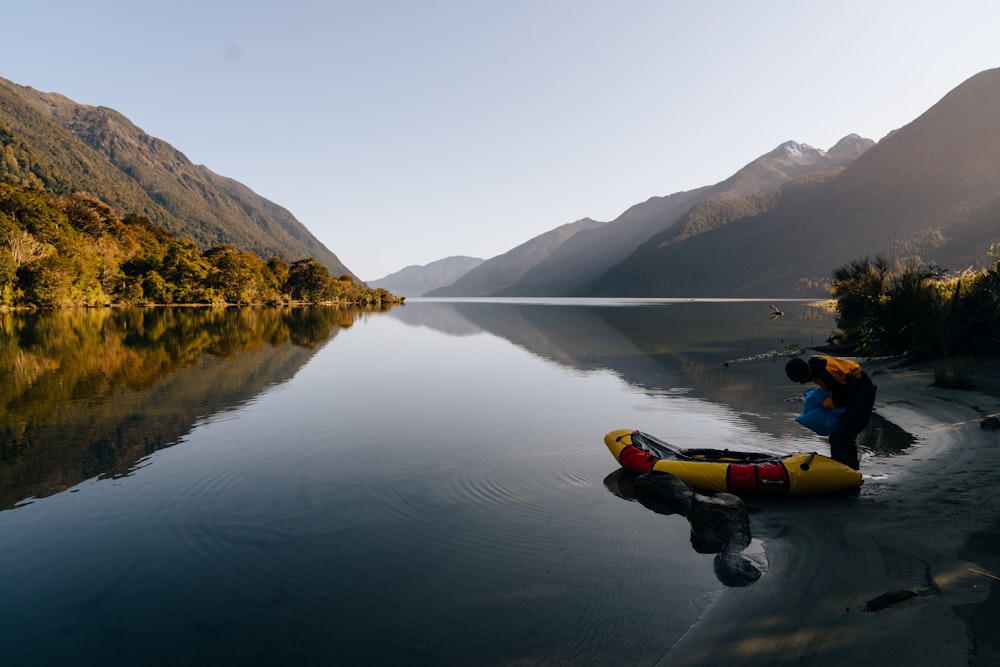 a person lying on a floating raft in a lake