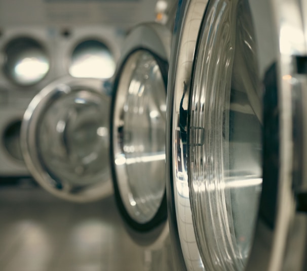 a row of silver and black washing machines