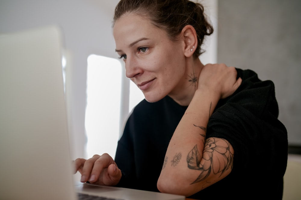 a person with tattoos looking at the camera