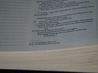 A close-up view of a page from a book containing text printed in a serif font. The subject matter appears to be religious or philosophical, given the references to human nature. The page also features footnotes indicated by small letters next to some of the text.