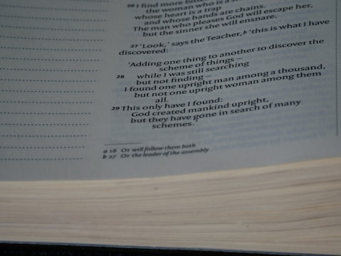 A close-up view of a page from a book containing text printed in a serif font. The subject matter appears to be religious or philosophical, given the references to human nature. The page also features footnotes indicated by small letters next to some of the text.