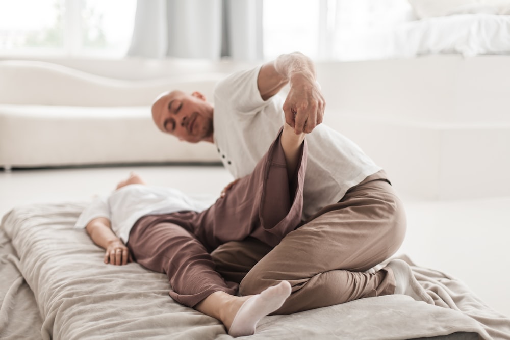 a man and woman lying on a bed