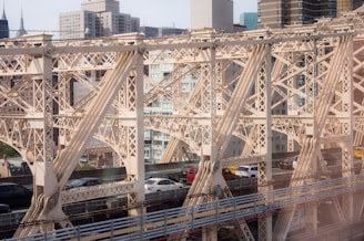 Foot over bridge spanning a busy city street, showcasing structural details.