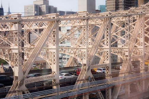 Foot over bridge spanning a busy city street, showcasing structural details.