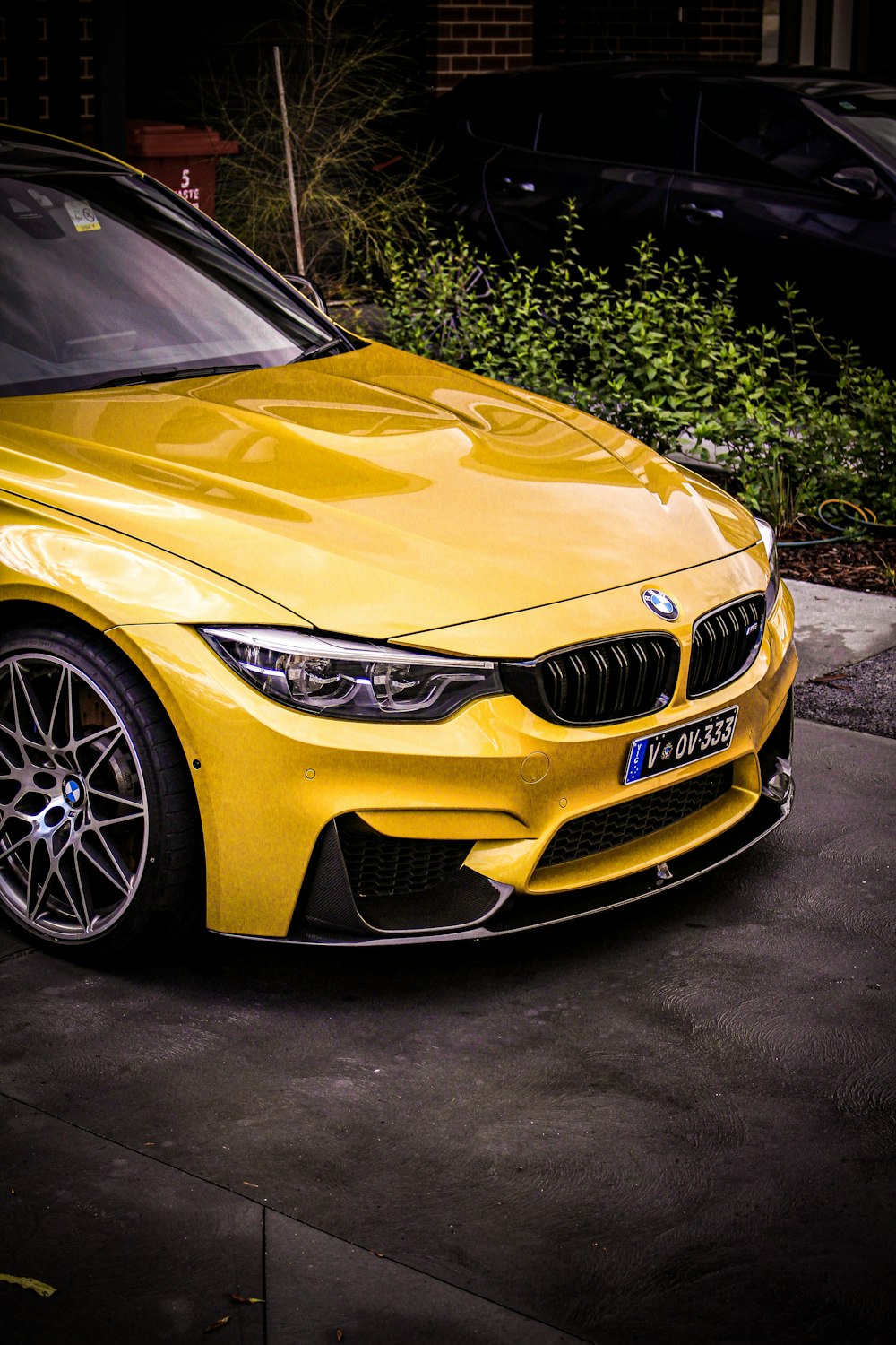 a yellow car parked on the side of the road