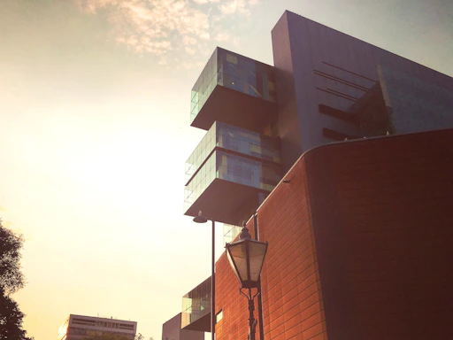 Modern architectural office building with clean lines and glass facade at sunset.