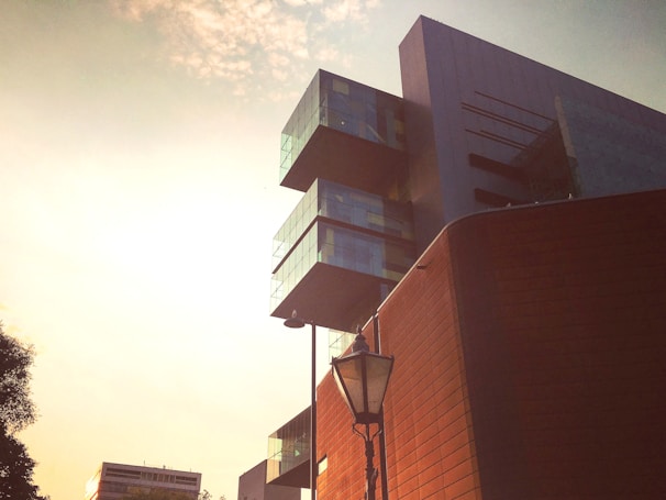 A detailed architectural visualization of a modern urban building at sunset.