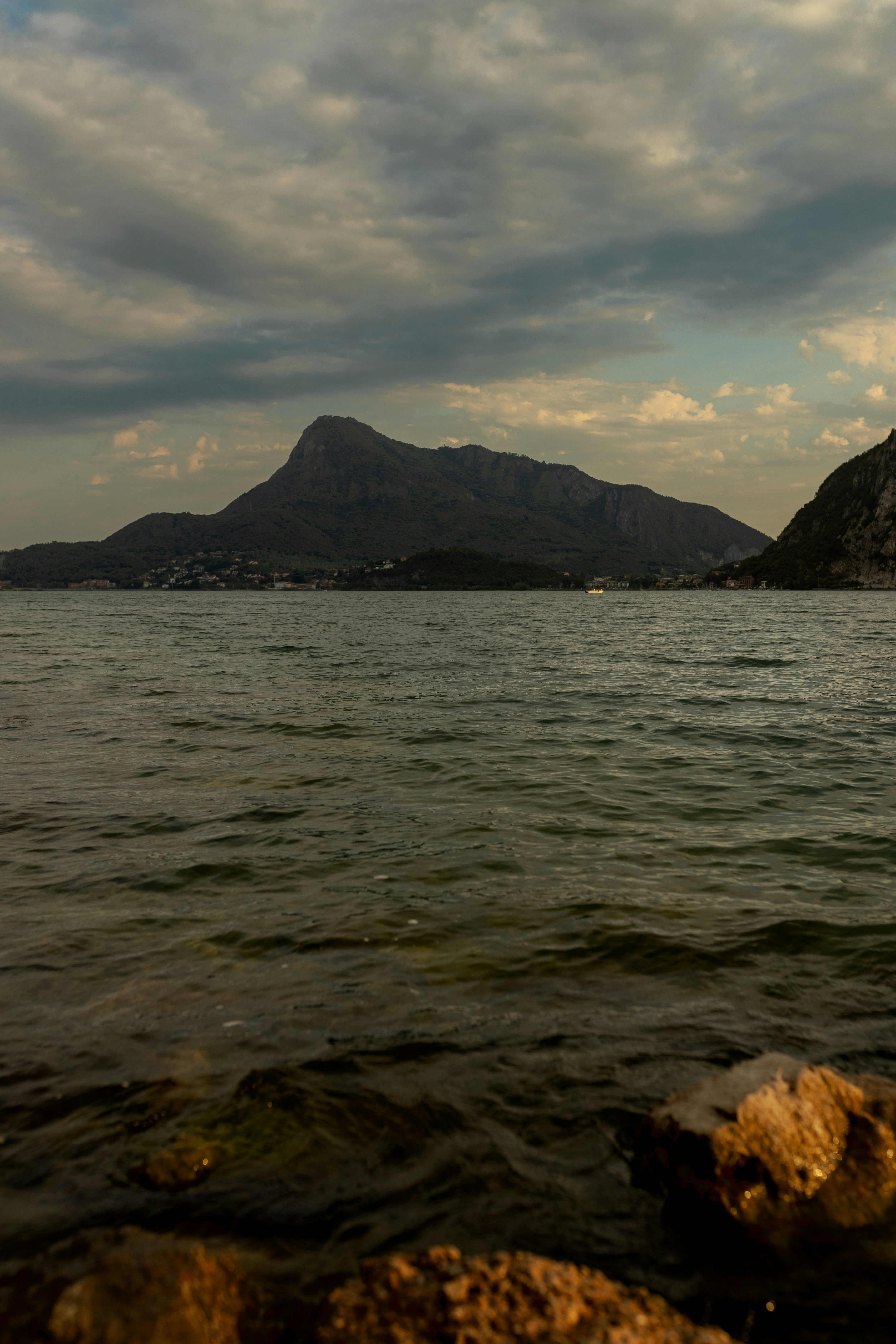 a body of water with a mountain in the background