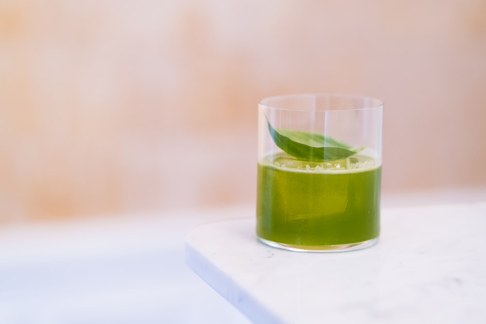 a glass of green liquid