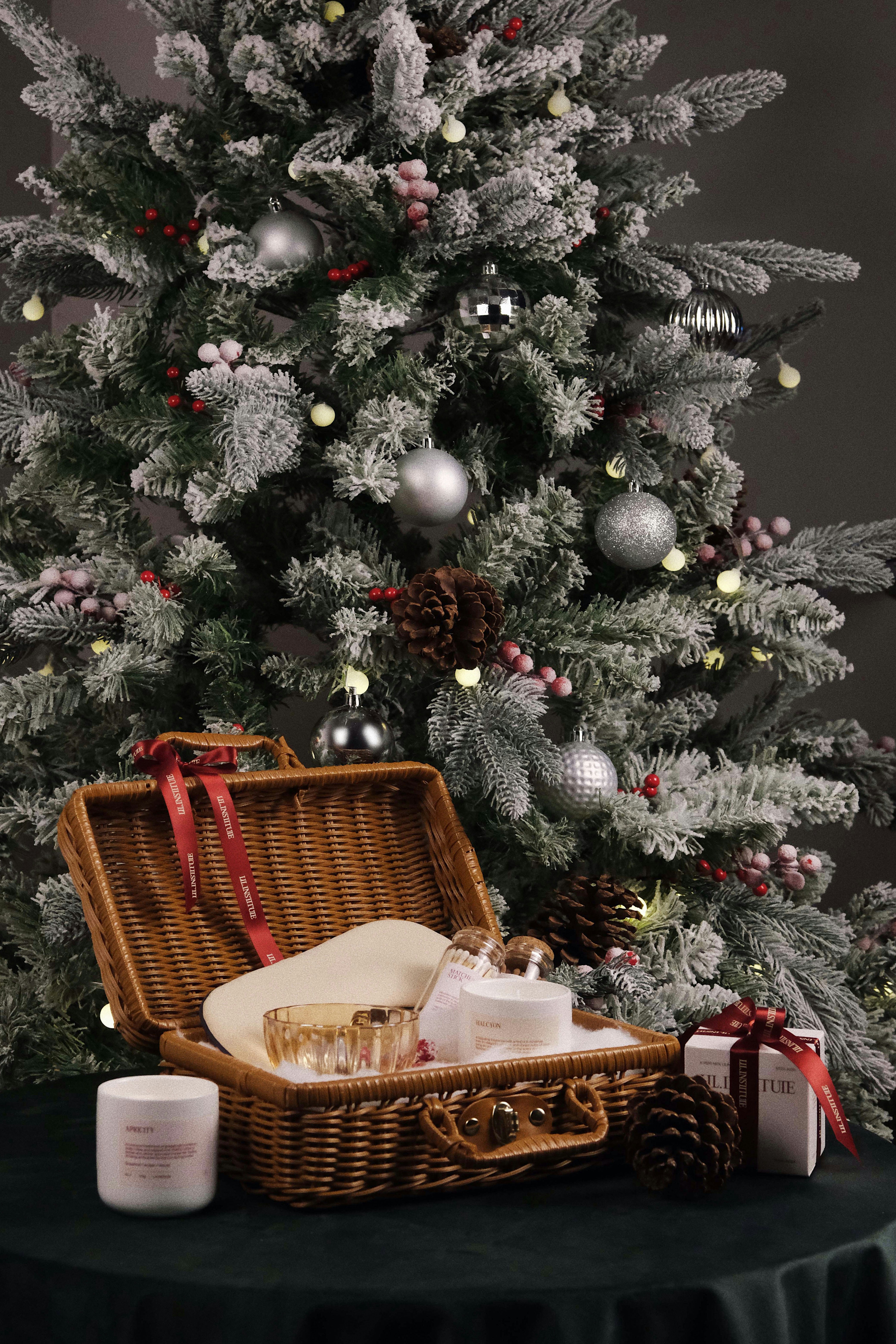 a basket of food next to a christmas tree