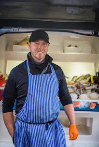 a man wearing a hat and apron