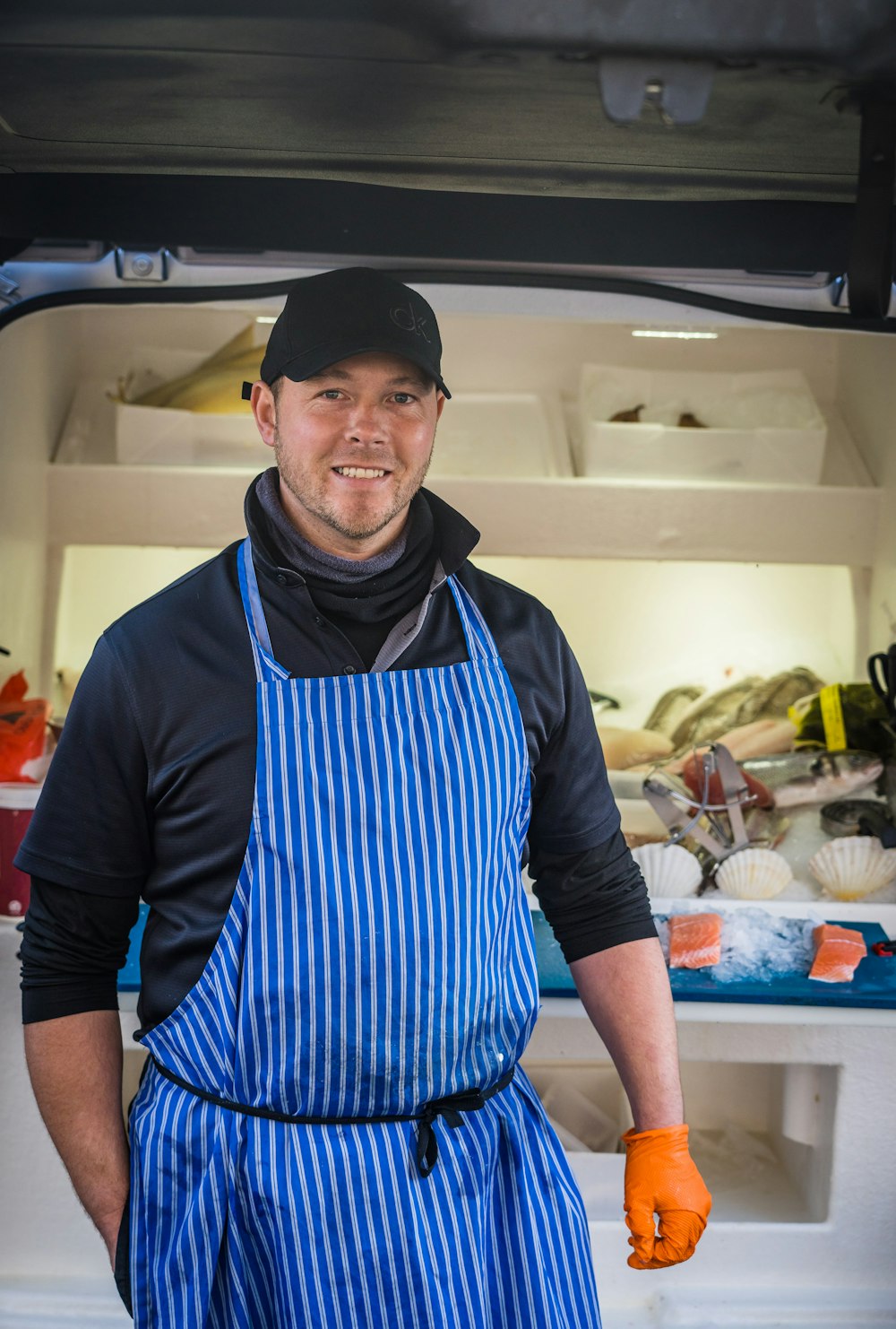 a man wearing a hat and apron