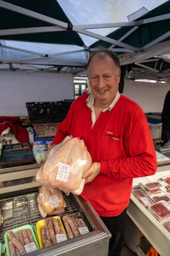 Small market shelves stocked with packaged chicken products.