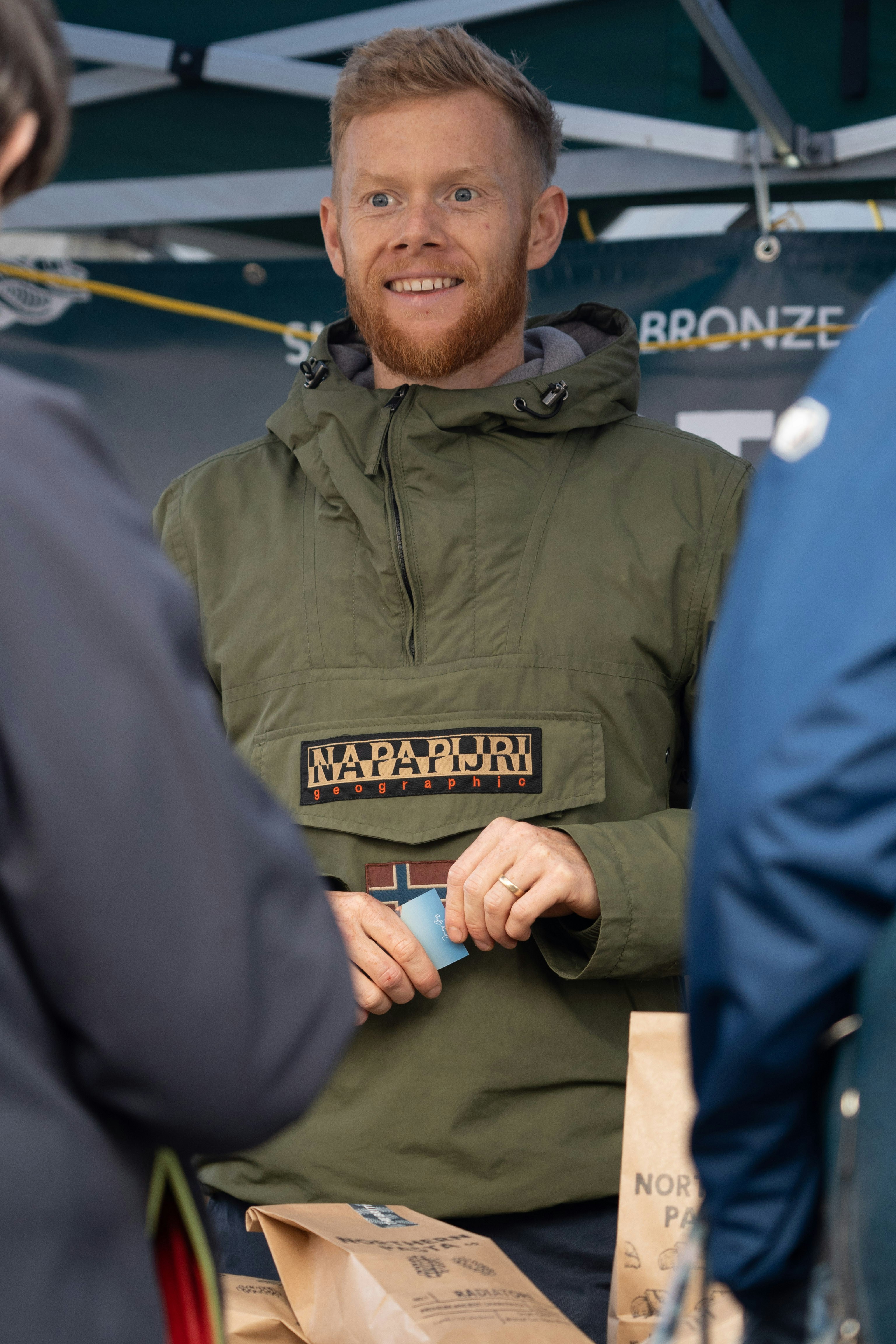 a man in a green jacket