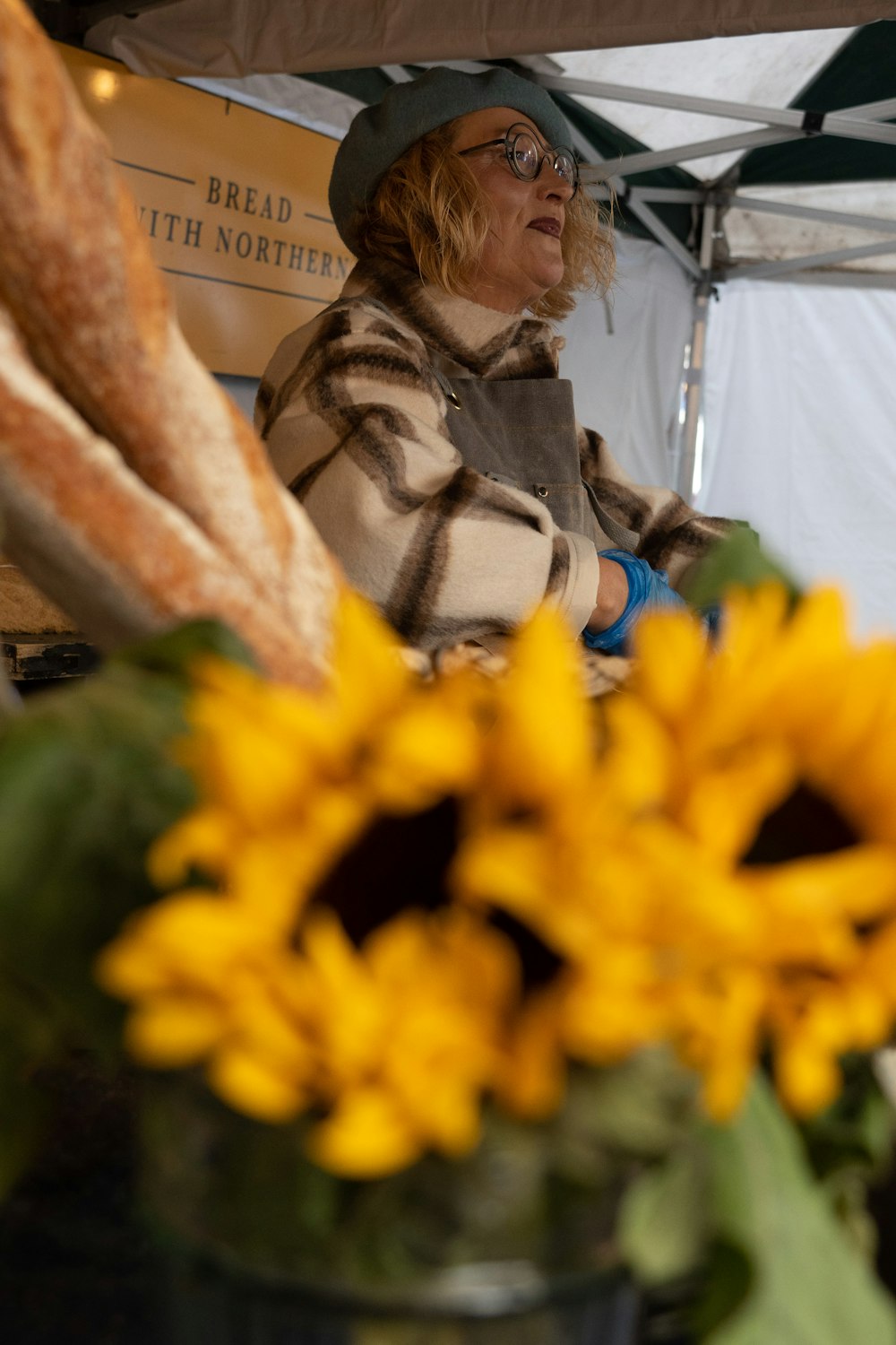 a person standing next to a flower