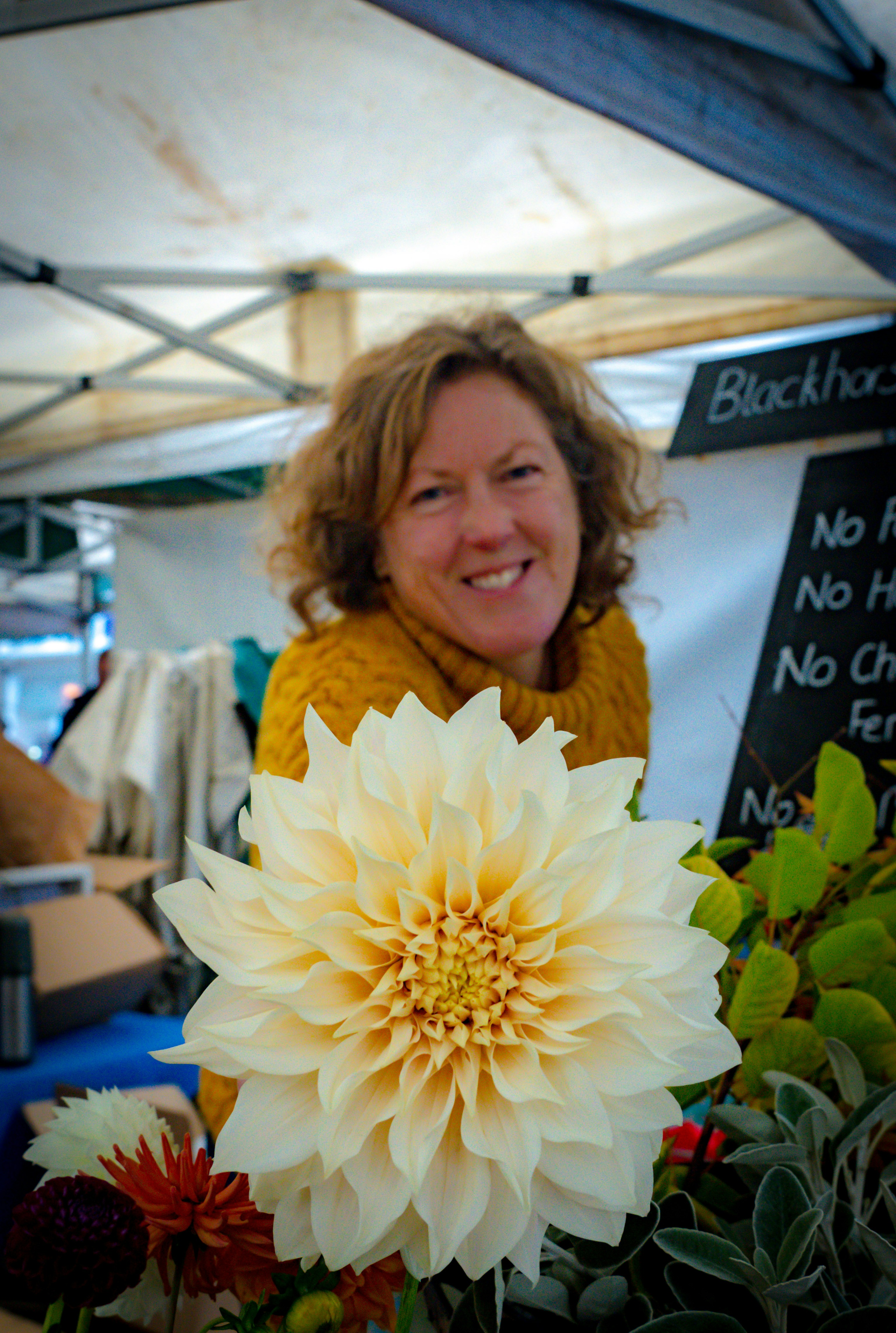 a person smiling with a large bouquet of flowers