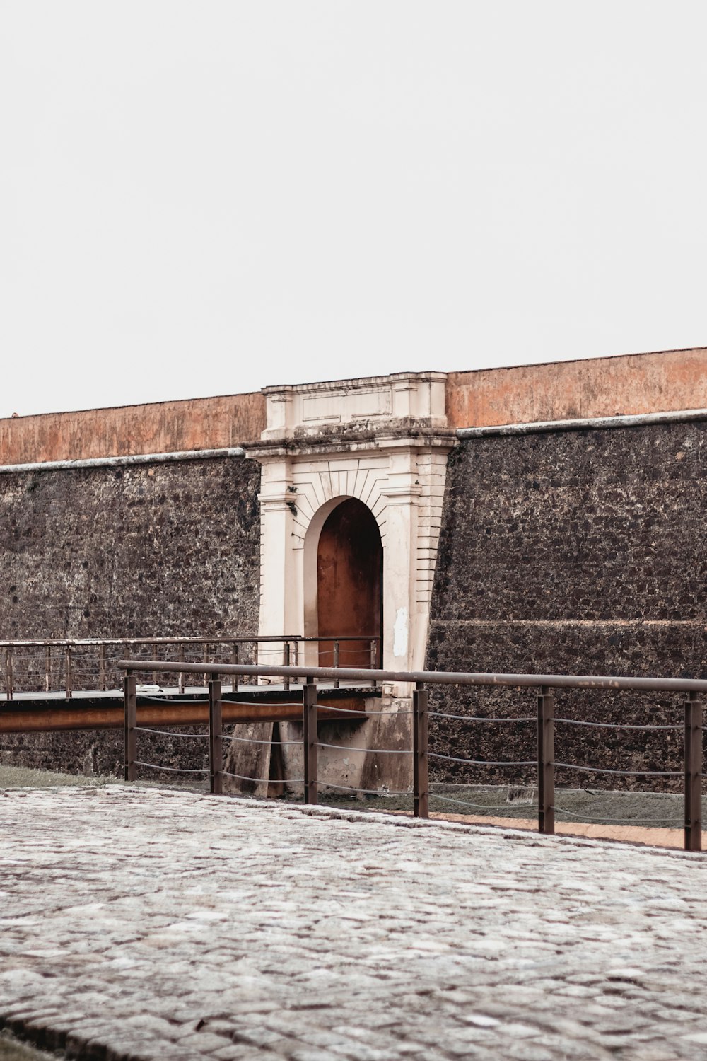 a stone building with a fence