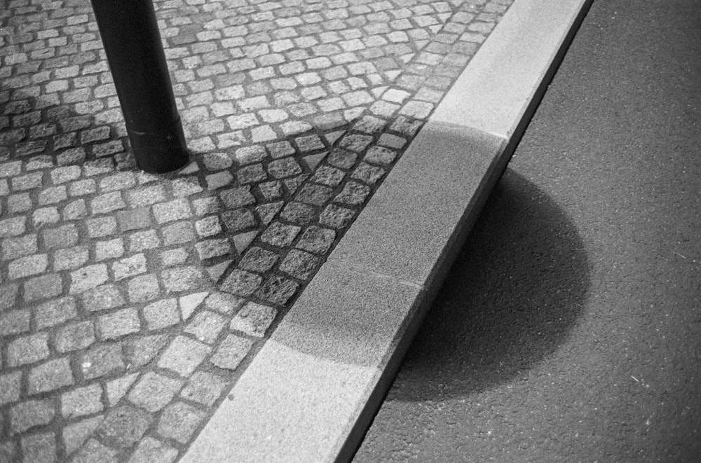 a shadow of a person on a brick sidewalk